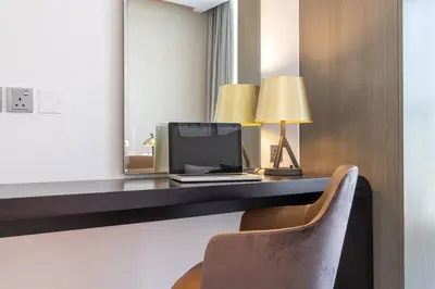 a room with a desk with a computer and a chair at Sophisticated Business Bay Canal View by Suiteable in Dubai