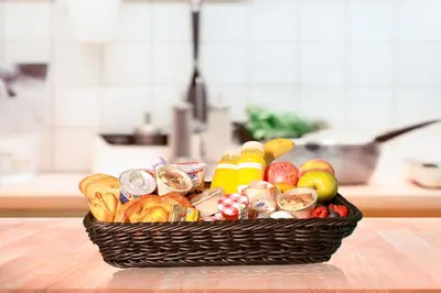a basket filled with different types of food on a table at Stunning 1BR in Bahar near JBR Beach in Dubai