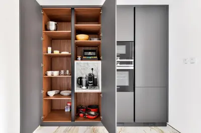 a kitchen with wooden shelves and a refrigerator at Stunning 1BR in Bahar near JBR Beach in Dubai