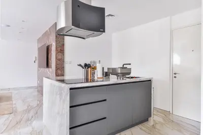 a kitchen with a sink and a tv on the wall at Stunning 1BR in Bahar near JBR Beach in Dubai