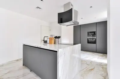 a kitchen with a white counter top in a room at Stunning 1BR in Bahar near JBR Beach in Dubai