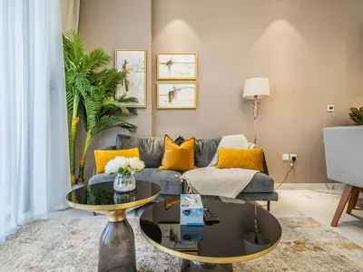 a living room with a couch and a table at Charming Condo With Balcony Near Dubai Hills Park in Dubai