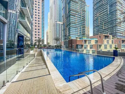 a large swimming pool in a city with tall buildings at StoneTree - DAMAC Heights 1 BR - Amazing Facilities in Dubai