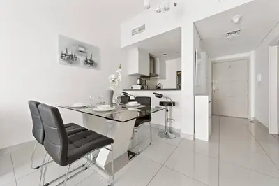 a kitchen with a table and chairs in a room at StoneTree - DAMAC Heights 1 BR - Amazing Facilities in Dubai