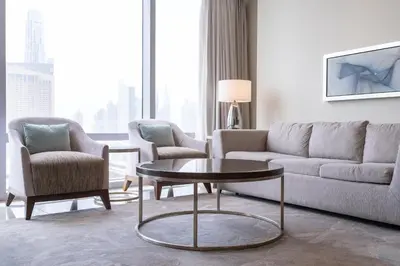 a living room with a couch and a table and chairs at New Listing - Serviced Apartment & TOP Amenities in Dubai