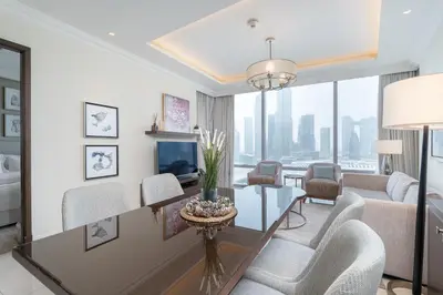 a living room with a table and chairs at New Listing - Serviced Apartment & TOP Amenities in Dubai